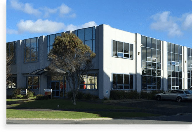 A modern two-story commercial building with reflective windows suitable for property management.